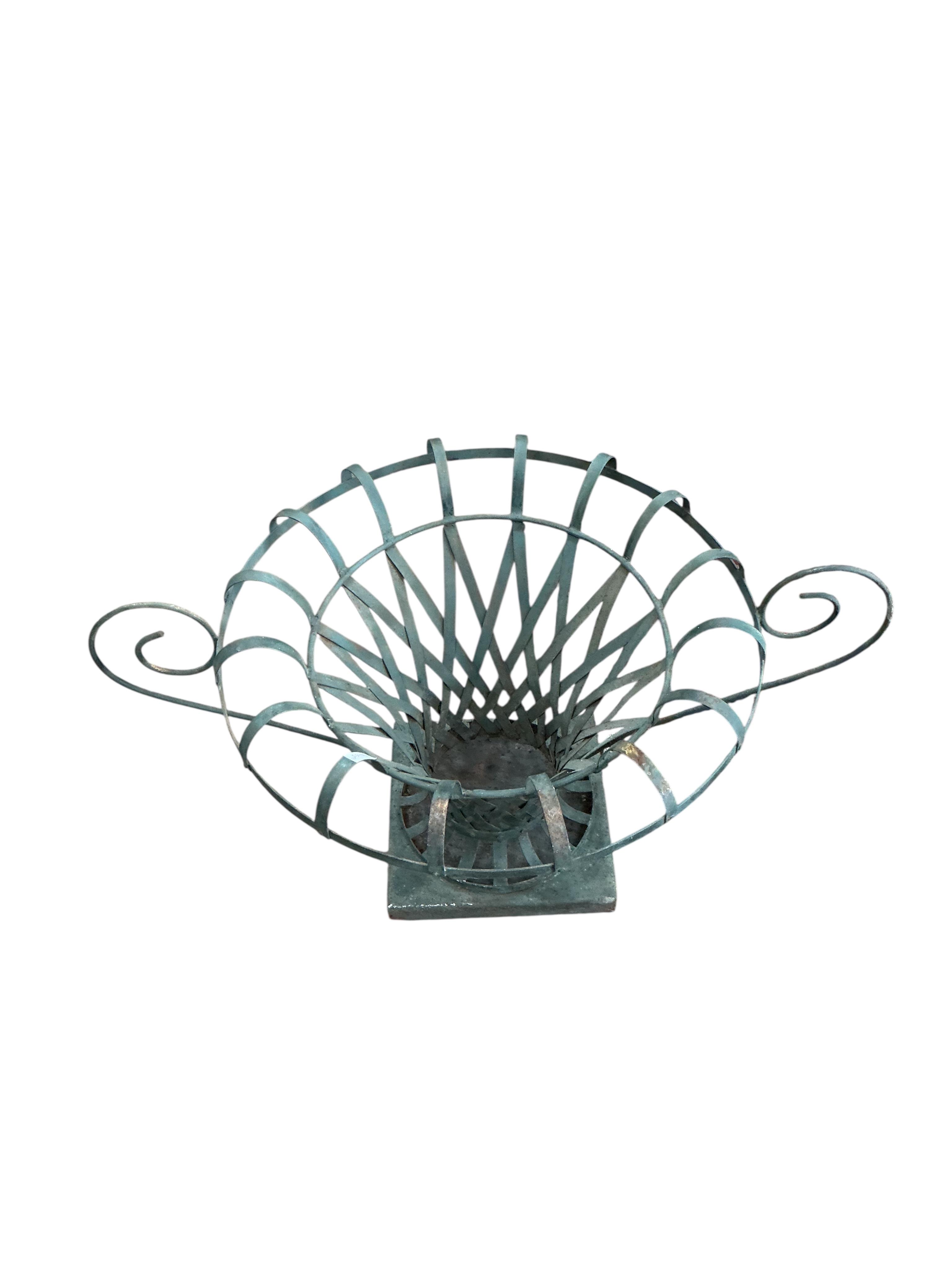 A pair of large painted wrought iron strapwork flower urns, diameter 90cm, height 44cm